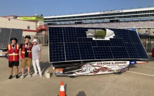 TXSES Executive Director Patrice Parsons with students and solar car